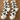 Pair of white socks with black and brown leopard print pattern on a wooden surface