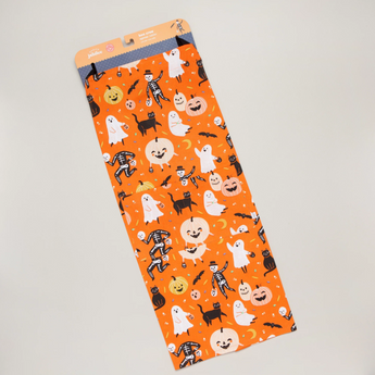 Close-up of Halloween Apron pattern featuring black cats, pumpkins, and skeletons