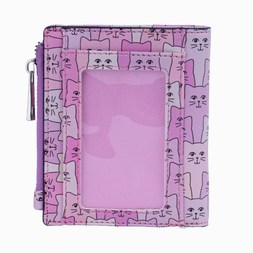 A close-up image of the Happy Cat Wallet, showcasing its vibrant pink color adorned with black smiling cat silhouettes. The wallet is open, revealing its various compartments, including a billfold, ID holder, zippered pocket, and credit card slips.