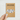 Kraft paper card with text 'I Came. I Saw. I Missed My Cat. So I Left.' held by a hand on a light gray background