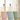 Three insulated tumblers in pastel pink, light blue, and sage green, each with a matching lid and a straw topped with a cute animal face. The tumblers are shown in a softly lit indoor setting with a blurred window background.