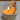 Ceramic cat-shaped candle holder with a lit candle inside on a neutral background