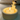 Candle with a cat-shaped wick holder on a white surface