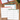 Three printed monthly calendar inserts for January, October, and September 2027 are arranged on a wooden desk with a red spiral notebook, green pen, and plant visible around them.