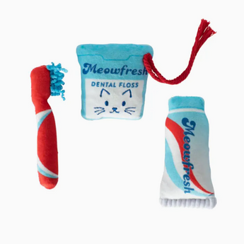 Three catnip toys: a toothbrush, toothpaste, and floss, perfect for dental hygiene playtime with your feline friend.