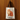 Tote bag with a cat illustration and text hanging on a wooden wall.