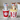 Two cat-shaped salt and pepper shakers with 3D glasses and popcorn, one in a cola cup, on a beige background.