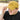 Person wearing a yellow cap with text, outdoors