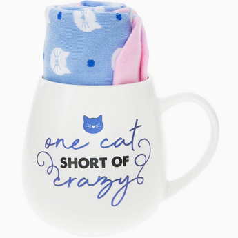 One Cat Short Of Crazy white mug with blue lettering and purple cat face.