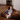 Dog lying on a striped dog bed in a kitchen
