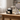 Black tissue box with a white cat design on a wooden table in a living room.