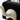 Close-up of a black and white plush toy with a curved armrest.