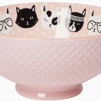 Close-up of light pink serving bowl with embossed cat face design