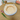 Round pet bed with cat ears on a textured surface