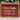 Wooden sign with 'Dear Santa, Beware of Attack Cat' text on a red background
