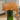 A sleeping orange cat-shaped bottle opener resting on top of a green glass bottle, shown in a softly blurred indoor setting.