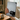Person holding a tablet with a black cat design on a blurred indoor background