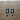 Black and white cat-shaped earrings on a wooden surface