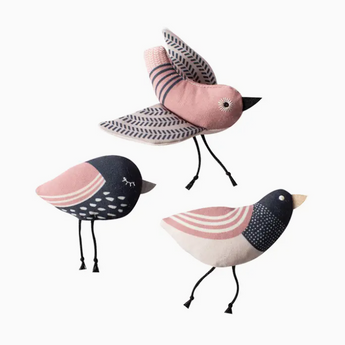 A trio of bird-shaped catnip toys in black, white, and pink colors, handmade from organic materials, with embroidered details and crinkle paper inside.