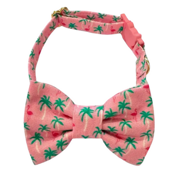 A detailed view of the Vacation Cat Collar, and matching bow tie showcasing its pink fabric adorned with playful palm trees and flamingo print, perfect for a tropical getaway.