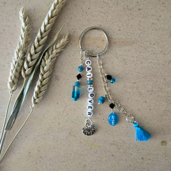 Turquoise cat lover keychain with fishbone bead and bright blue tassel.