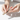 Person applying a leopard print bandage to a small cut on a light background