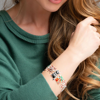 Model wearing Holiday Cats Bracelet, highlighting its festive design and magnetic closure.