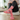 Person wearing pink socks with black cat patterns in a home setting