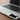 Black cat-shaped sticker on a laptop keyboard