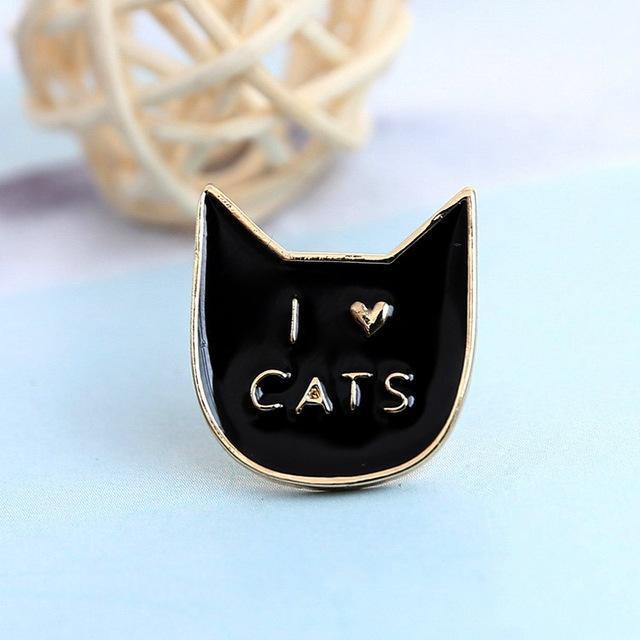 This black cat pin features the print "I Heart Cats" in gold printed across a black cat face.