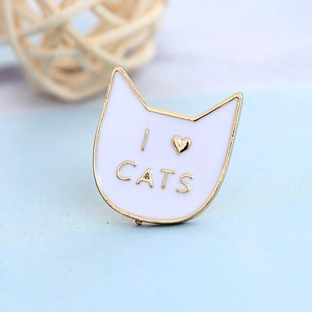This cat brooch features a white cat face and the text "I Heart Cats" printed in a golden hue.