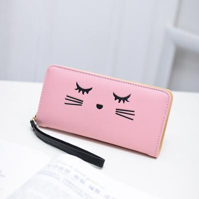 This wristlet wallet is decorated with an embroidered kitty cat face.