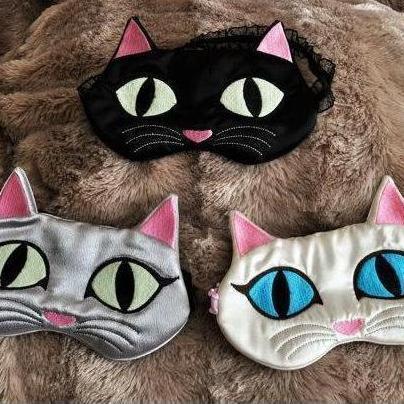 Cat sleep mask featuring handmade embroidered cat face and glow in the dark eyes
